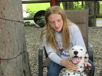 Girl petting dog at Rip Van Winkle Campgrounds in the Catskills